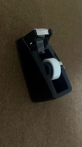 Black desktop tape dispenser with roll