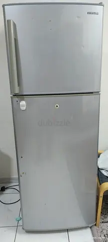 Silver two-door refrigerator with top freezer - used