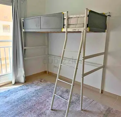 White metal loft bed with ladder — single elevated bed