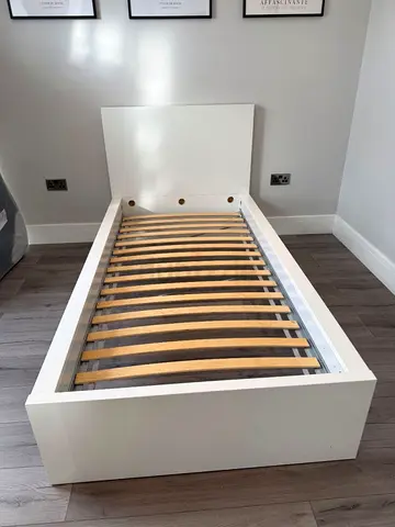 Single white wooden bed frame with slatted base — good condition