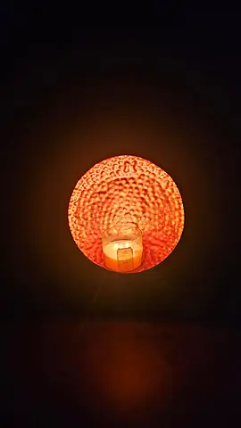 Wall-mounted decorative sconce with textured glass shade