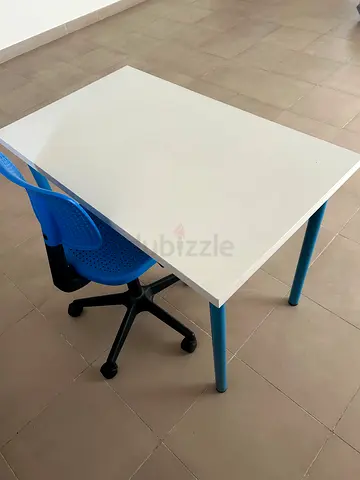 Simple white study table with blue legs and matching blue chair