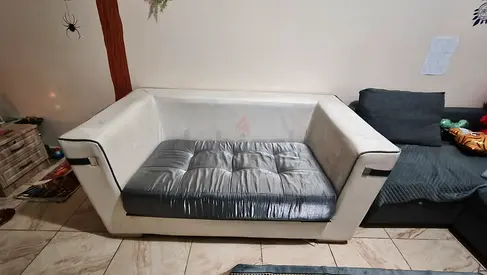Two-seater white fabric sofa with removable grey seat cushion