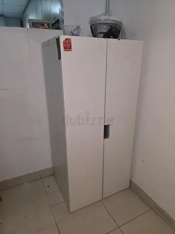 Used white metal storage cabinet