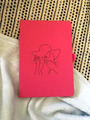 Pink hard-cover notebook with line-art cover
