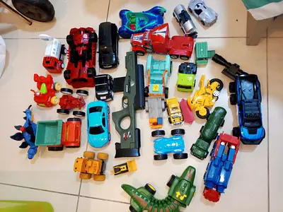 Assorted Toy Vehicle Collection and Toy Gun