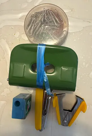 Assorted stationery set: hole punch, stapler, staples, paper clips, corner punch