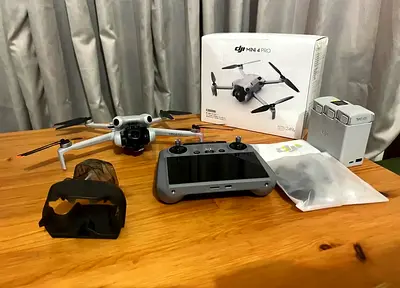 DJI Mini 4 Pro drone with RC controller and extra batteries - excellent condition