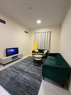 Luxury one-bedroom apartment with a living room and balcony offering an open view. Ajman, Al Muwaiha