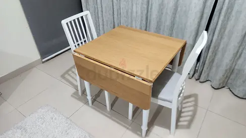 Small wooden drop-leaf dining table with 2 chairs