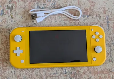 Yellow Nintendo Switch Lite handheld console working perfectly