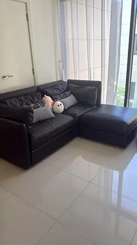 Two sofa sets - Black L-shaped Leather Sofa with Ottoman Blue Grey sofa set with stool.