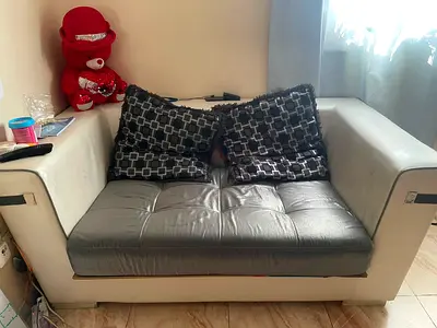 Two-seater white fabric sofa with removable grey seat cushion