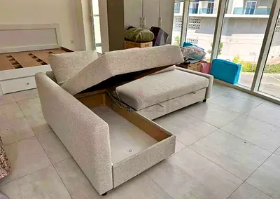 Ikea Light grey fabric L-shaped storage sofa with pull-out bed