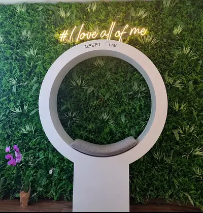Modern circular photo booth/display pod and wall grass decoration and i love all of me lightinig