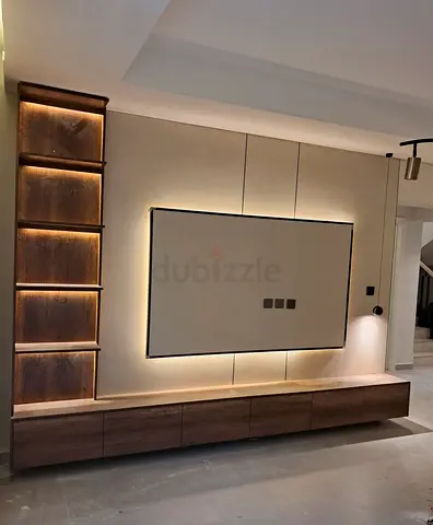 Modern wall-mounted TV entertainment unit with built-in shelving and LED backlighting