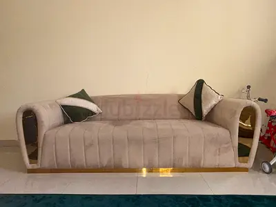 Beige upholstered 3-seater sofa with gold trim