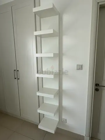 Long white wall-mounted shelving unit / display shelf