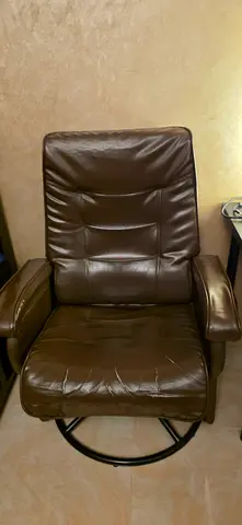 Brown leather reclining armchair with swivel base - good condition