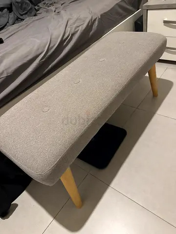 Light grey upholstered bench with wooden legs - good condition