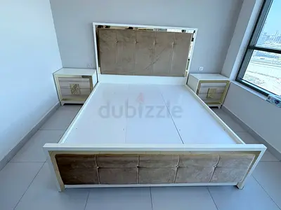 King size upholstered bed frame with two matching bedside tables and dresser