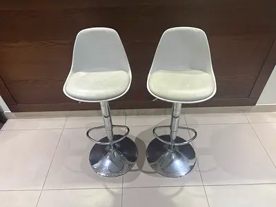 Pair of adjustable white bar stools with chrome base