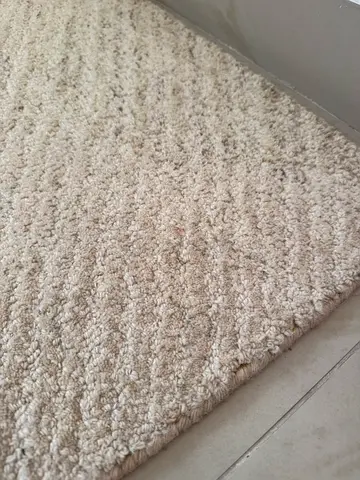 Beige textured area rug - good condition