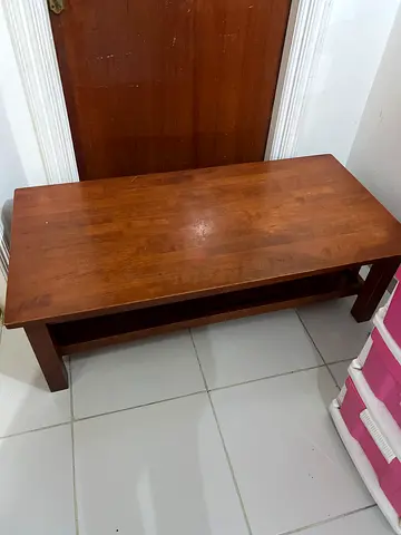 Solid wood coffee table with lower shelf - good condition