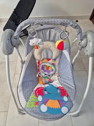 Baby electric swing/rocker with toy bar - good condition