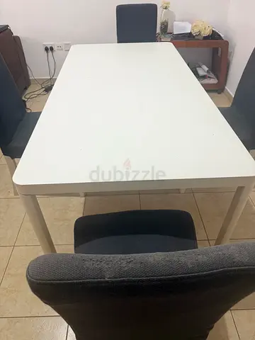 White rectangular dining table with 4 dark grey chairs - good condition
