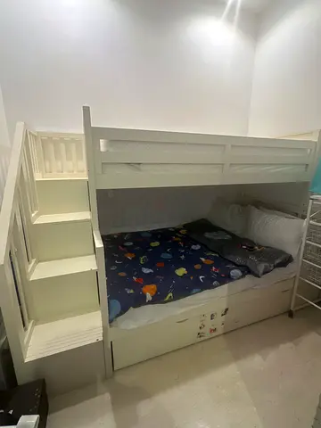 White wooden bunk bed with storage steps - good condition including mattress