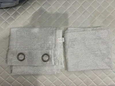 Grey eyelet curtains with subtle textured pattern.100/200m