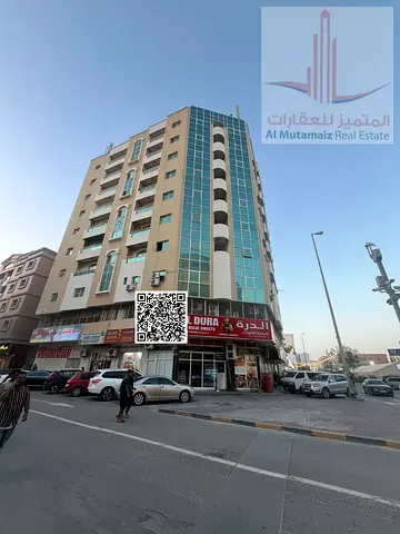 Two-bedroom apartment with a living room and central air conditioning; prime location in Al Rumaila 1.