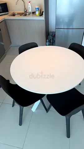 IKEA White round dining table with 4 black chairs - compact set