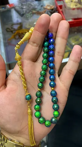 A rosary with 33 beads, a 925 sterling silver tassel design, and a heat-sensitive, color-changing
