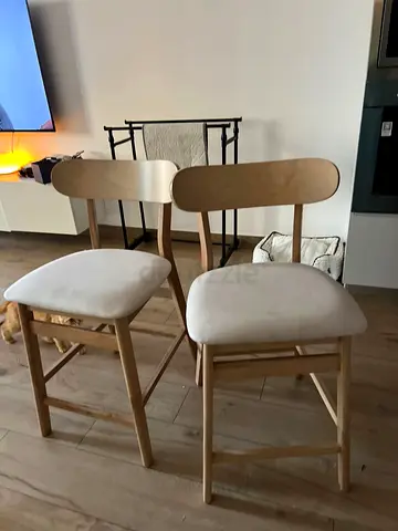 Pair of light wood dining chairs with upholstered seats