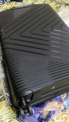 Black hard-shell carry-on suitcase with spinner wheels
