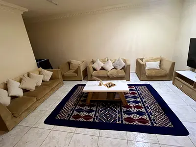 Beige 3-seater sofa set with armchairs and patterned navy rug - good condition