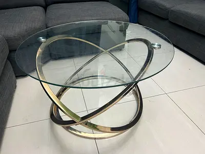 Round glass coffee table with modern metal ring base