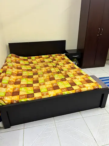 Queen bed frame with mattress and attached headboard cabinet - dark wood