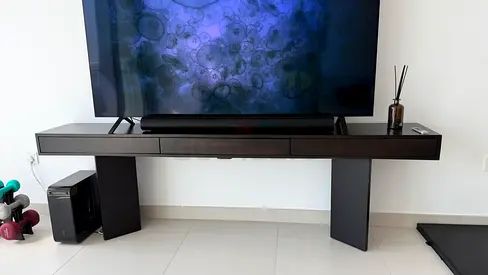 Low-profile modern CB2 TV console / entertainment unit in dark wood