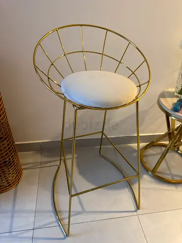 Gold metal accent chair with white cushion — modern design