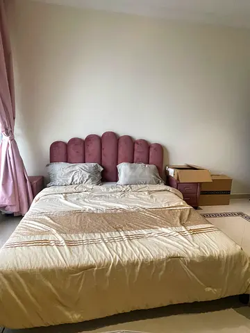 Queen bed with pink upholstered headboard - good condition