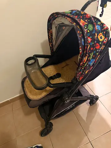 Used single baby stroller with colorful canopy and tray - good condition