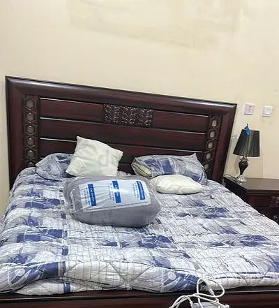 Sturdy Dark Wood King Size Bed with Carved Details