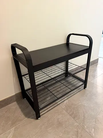 black entryway bench with and two lower shoe racks