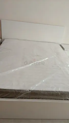 White  bed frame with headboard and mattress