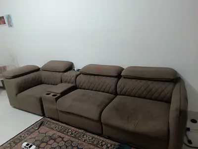 Comfortable 4-seater brown fabric reclining sofa with cup holders and charging ports