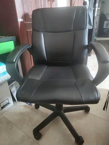 Black ergonomic office chair with armrests