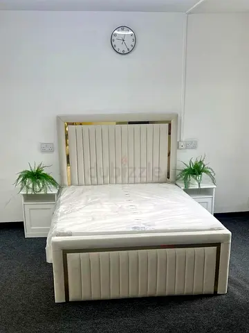 Queen upholstered bed frame with padded headboard and footboard
